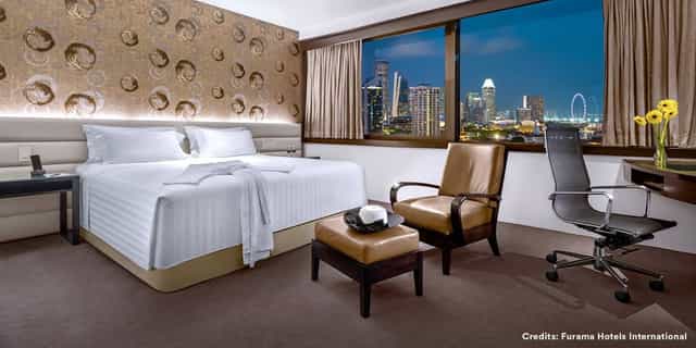 Furama City Centre executive room with workspace and skyline view for corporate events and meetings.