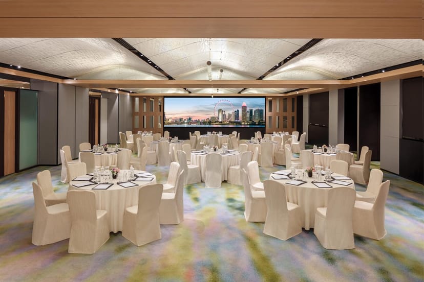 Luxury ballroom with integrated AV display, perfect for corporate banquets and gala dinners.