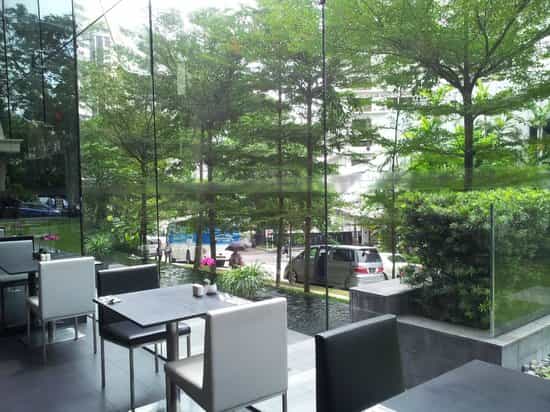 Bright networking space with glass walls and biophilic design for corporate events and workshops.