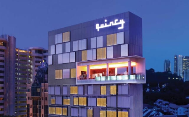 Sleek boutique hotel bar in Singapore at dusk for executive retreats and networking receptions.