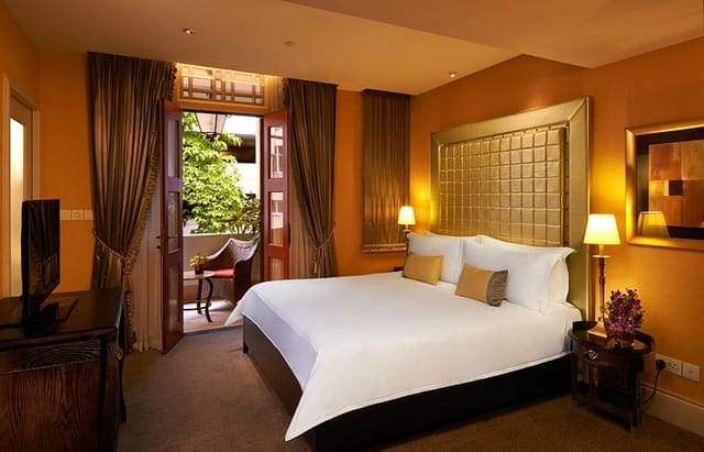 Luxury hotel suite with private balcony at The Scarlet Singapore for VIP conference delegates.