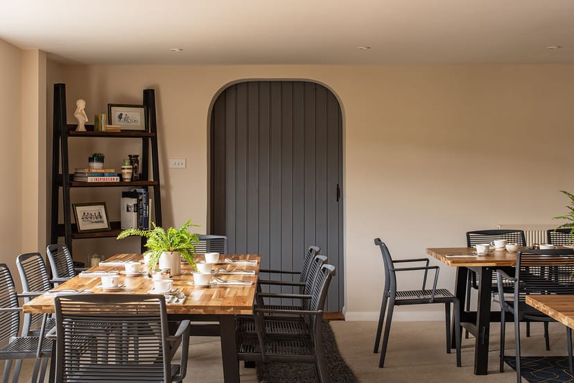 Modern meeting space at Brookfield Barn with wooden tables, ideal for workshops and gatherings.