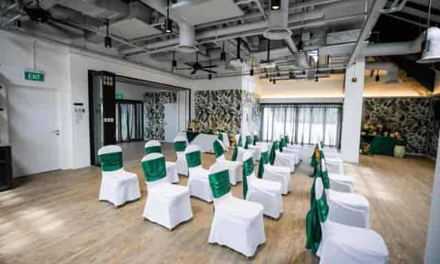 Elizabeth Suite event space with green chairs for modern corporate ceremonies.