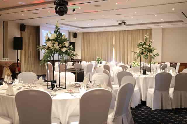 Stuart Room wedding reception with elegant floral centerpieces in a formal gala ballroom setting.