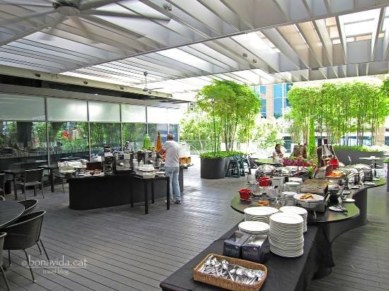 Modern coffee station in a bright, semi-outdoor cafe space for corporate events and workshops.