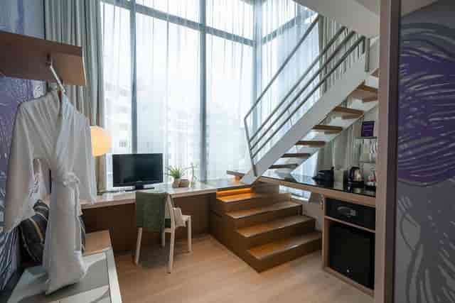 Studio M Hotel duplex guestroom, ideal for executive meetings and corporate events.