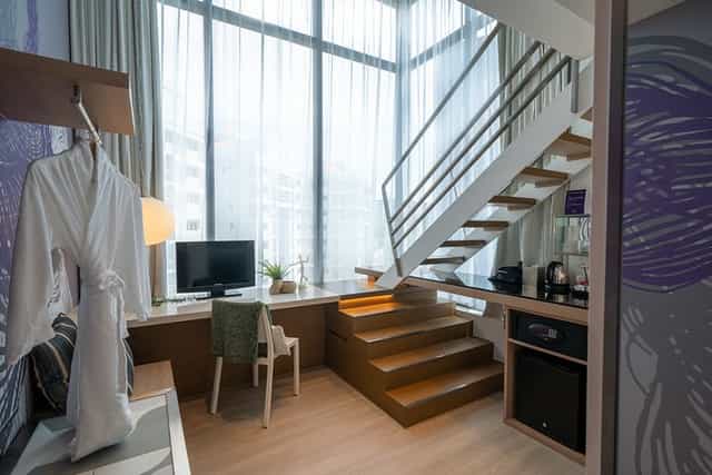 Studio M Hotel duplex guestroom, ideal for executive meetings and corporate events.