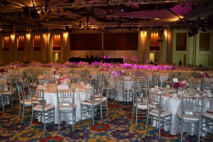 Fort Worth Convention Center ballroom, elegant gala setup with round tables and ambient lighting.