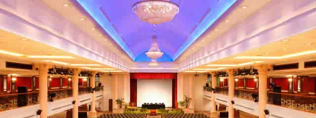 Grand Ballroom at Orchid Country Club with tiered theater seating for corporate presentations.