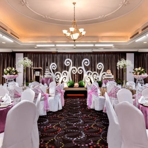 Wedding reception in Emerald Suite, Orchid Country Club featuring ballroom floral decor.
