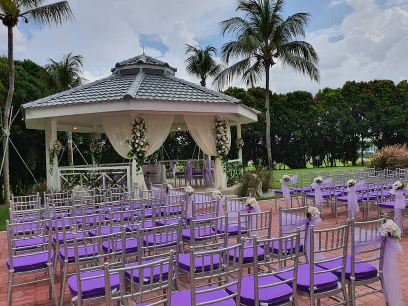 Outdoor wedding ceremony at Orchid Country Club with gazebo and elegant aisle seating.