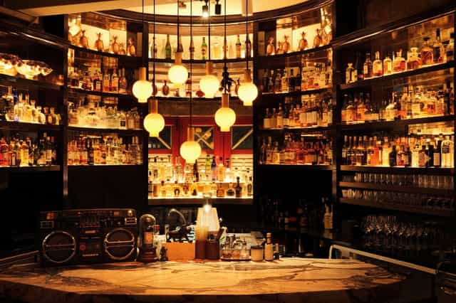 1939 Singapore cocktail bar with dramatic lighting for VIP receptions and networking events.