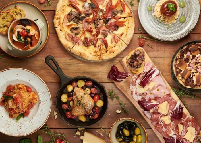 Casual networking reception at Prego featuring shareable menu and interactive team dinner setup.