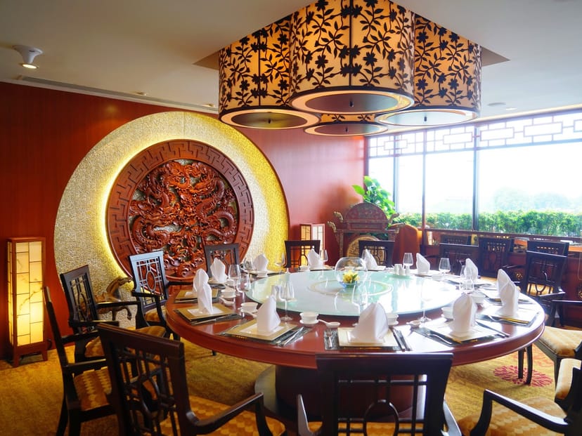 High-end private dining room with ambient lighting for formal business dinner and networking.