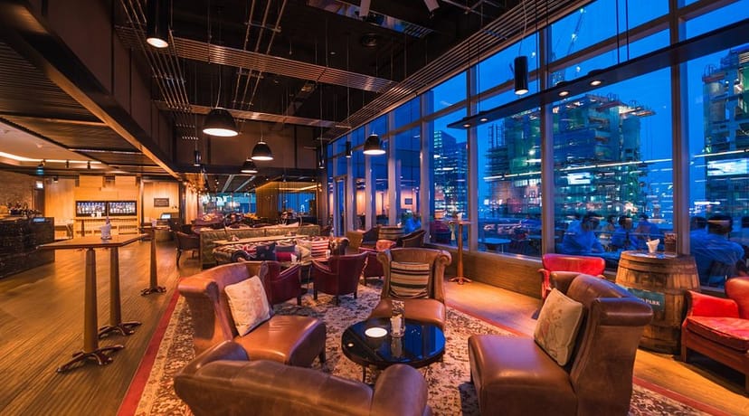 Industrial lounge at Cook & Brew with panoramic views for networking events and cocktail receptions.