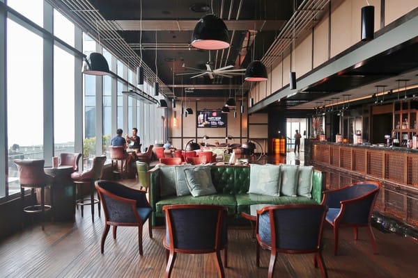 Upscale Cook & Brew lounge for corporate networking and VIP events with natural light.