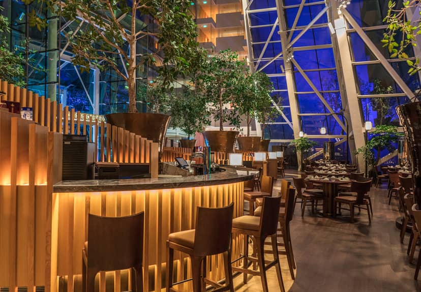 Blossom Restaurant atrium with lush greenery for cocktail receptions and networking mixers.