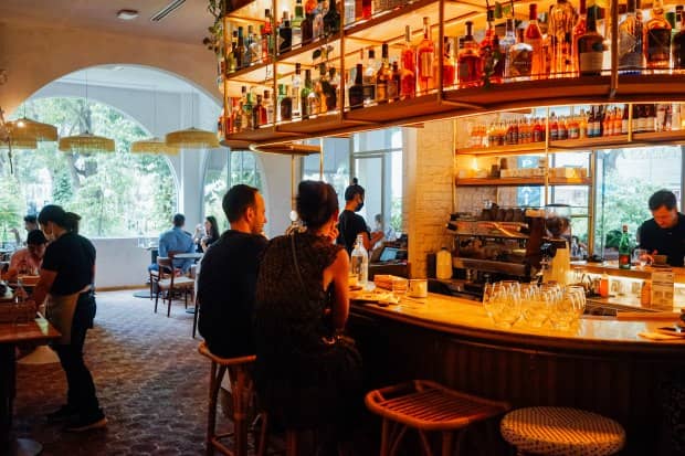 Merci Marcel Orchard venue for networking mixer and happy hour events with sophisticated bar decor.