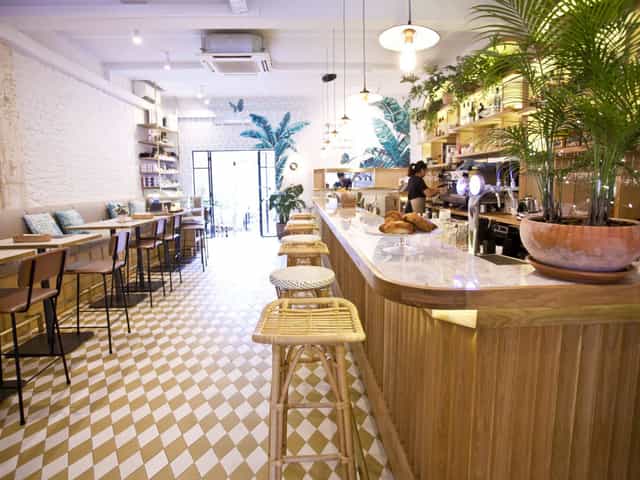 Merci Marcel Orchard bar with rattan seating, ideal for corporate networking and breakout events.
