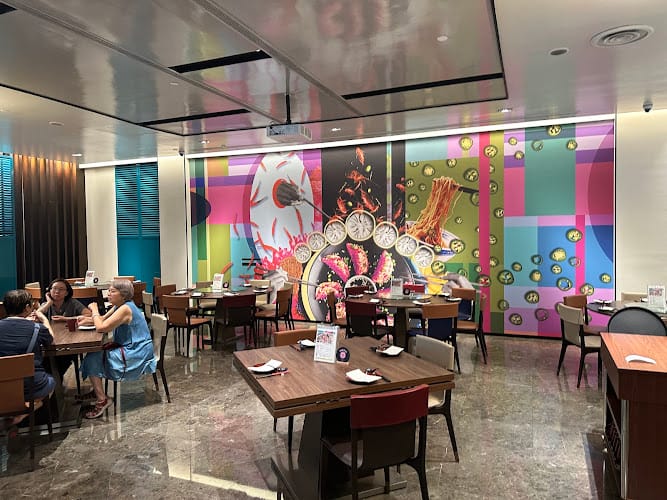 Contemporary dining space at Restaurant in Yuè @ Aloft with mural for events and group lunches.