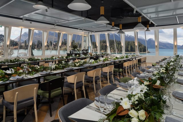 Clancy’s Room banquet setup with lake views, floral runner, ideal for corporate galas or weddings.