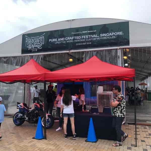 Motorcycle display under branded event marquee for outdoor corporate activation and roadshow.