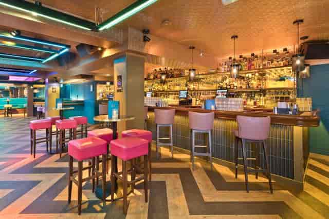 Modern Dylan's Kitchen and Bar lounge with vibrant seating for networking events and receptions.