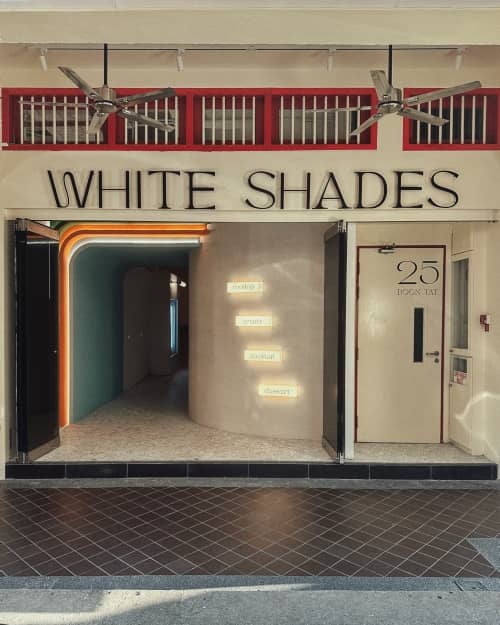 Modern rooftop venue entrance with white shades for branded product launches and trendy parties.