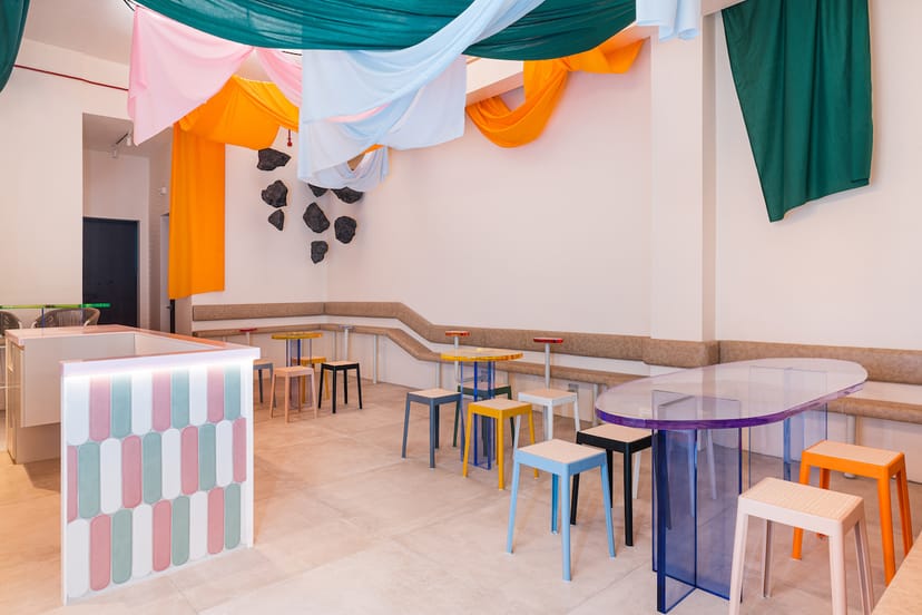 White Shades dessert bar with ceiling draping for networking events and pop-up workshops.