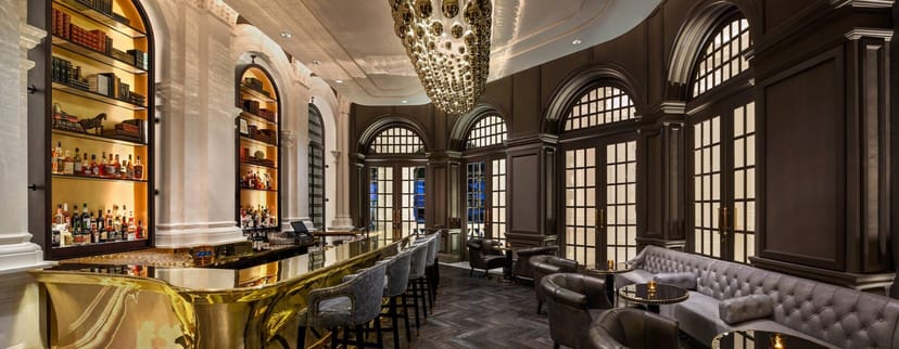 Sophisticated Raffles Room bar, luxury interior for executive networking and VIP corporate events.