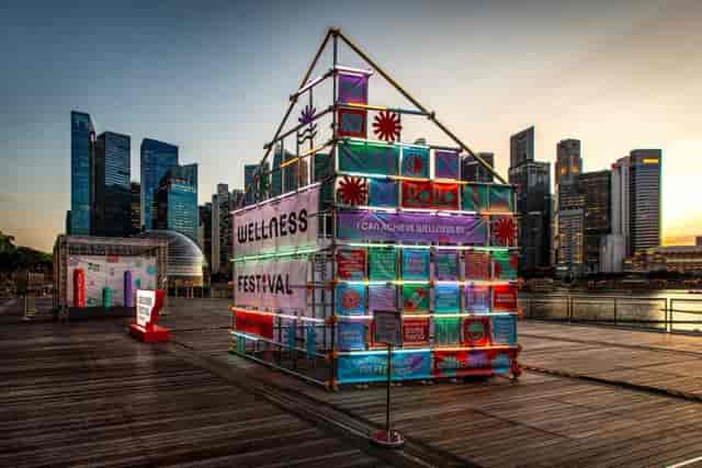 Wellness Frequent Flyer Plus modular scaffold brand activation at a Singapore outdoor event.