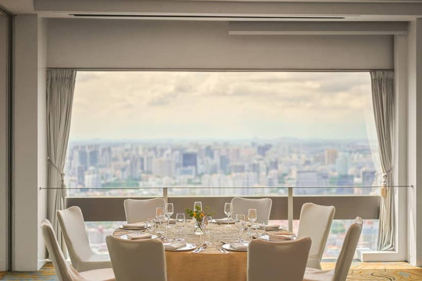 Elegant dining table with city view at SKAI Suites, perfect for upscale events and gatherings.
