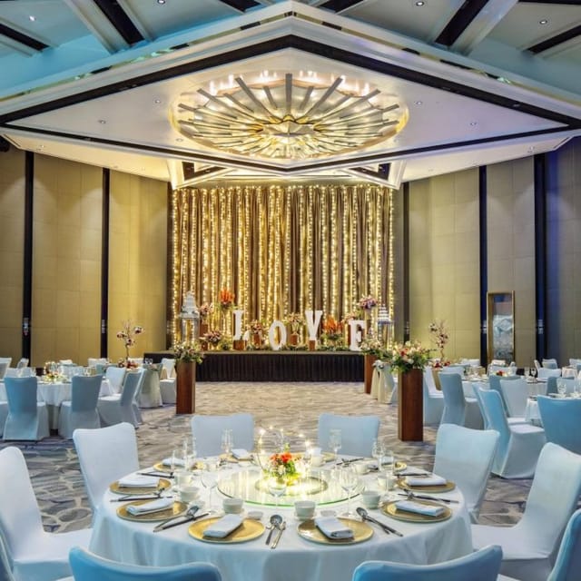 Atrium Ballroom with golden drapery, perfect for elegant weddings and celebrations.