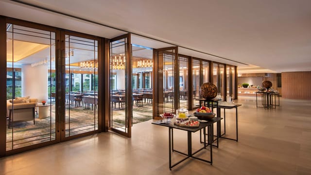 Elegant ballroom in Andaz Singapore for meetings and events, featuring natural light and refreshments.