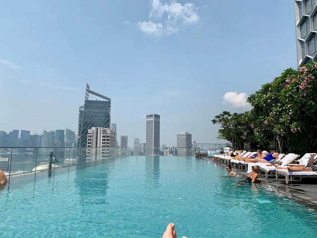 Rooftop pool at Andaz Singapore with city skyline, perfect for upscale events and gatherings.
