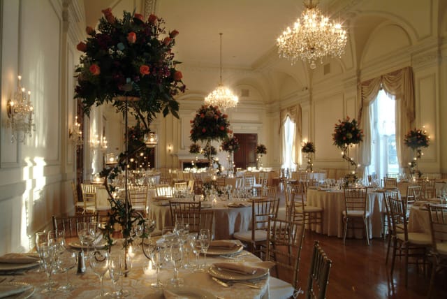 OHEKA CASTLE grand ballroom with tall floral centerpieces for elegant wedding gala.