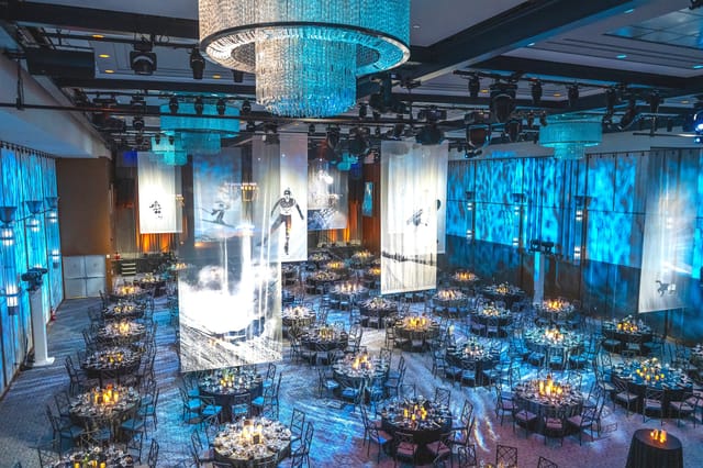 Ballroom gala with projection mapping and vertical banners for corporate event and luxury wedding.