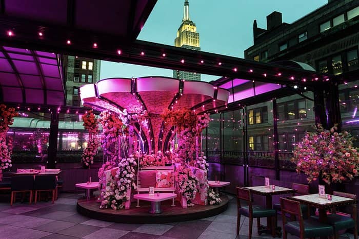 Rooftop bar at Moxy Times Square with floral decor for VIP events and networking.