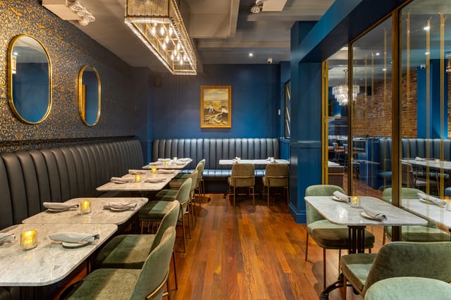 Upscale restaurant with marble tables, ideal for private dining and corporate events.