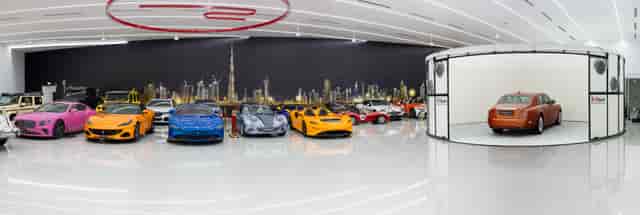 Luxury event space in Dubai with skyline mural for high-end brand activations and vehicle staging.