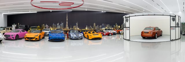 Luxury event space in Dubai with skyline mural for high-end brand activations and vehicle staging.