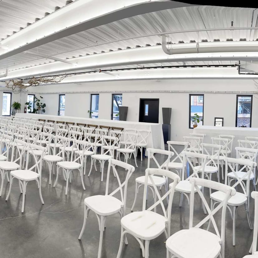 Industrial penthouse event venue with theater seating, ideal for corporate or social gatherings.