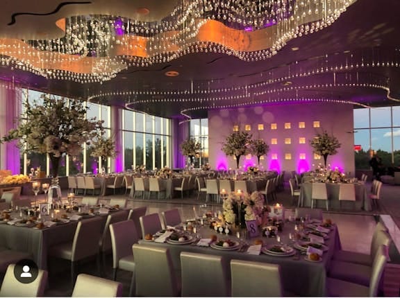 Modern rooftop wedding ballroom with purple LED lighting for galas and elegant events.