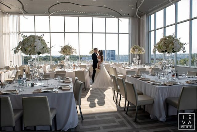 High-end rooftop wedding ballroom with floor-to-ceiling windows, perfect for luxury event venues.