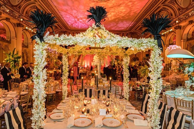 Gala event setup in NYBG Garden Terrace Room with ornate floral centerpieces and luxury lighting.
