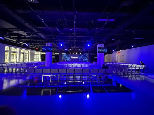 Center415 North Exhibit: Industrial-chic event space with moody theater-style lighting.