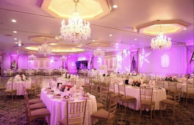 Villa Barone Manor ballroom featuring purple holiday lighting and snowflake projections for banquets.