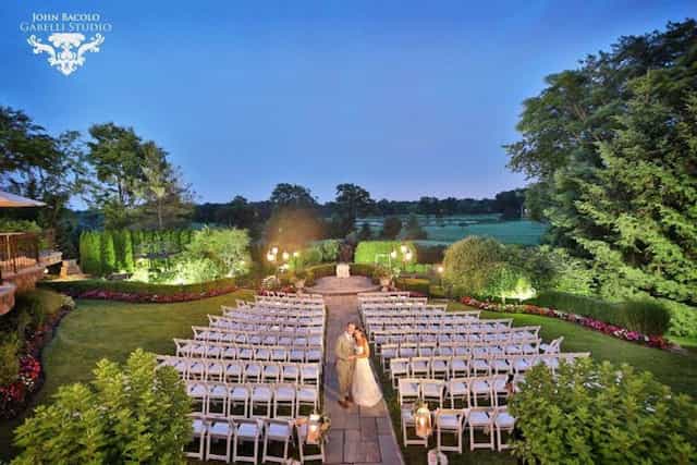 The Park Savoy Estate garden wedding ceremony with twilight lighting.
