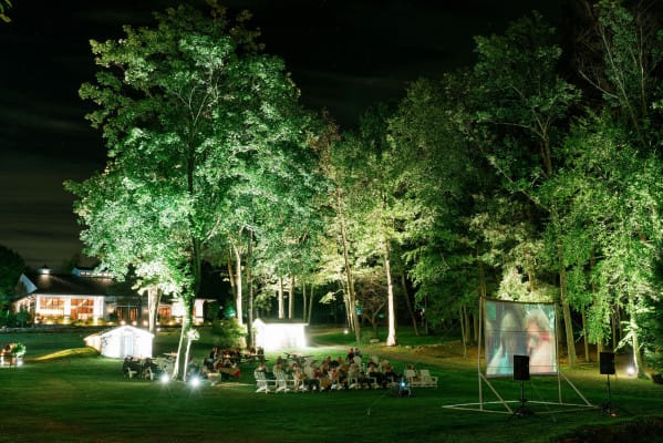 Outdoor amphitheater at Cedar Lakes Estate with cinematic lighting for evening corporate events.