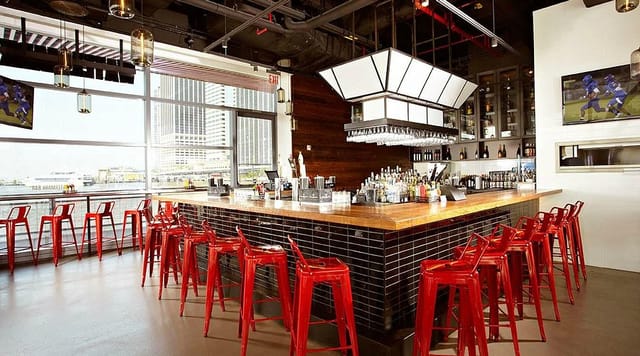 Industrial-chic event venue with skyline views for networking mixers and cocktail receptions.